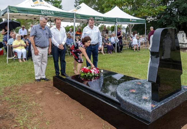 Councillor David Pahlke, Mayor Paul Pisasale and Councillor Paul Tully look on as Member for Ipswich Jennifer Howard places a flower on the grave. Picture: Lyle Radford