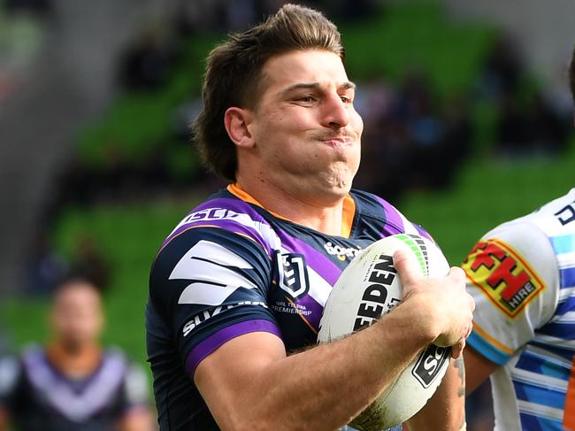 Curtis Scott of the Storm (left) is seen in action during the Round 23 NRL match between the Melbourne Storm and the Gold Coast Titans at AAMI Park in Melbourne, Sunday, August 25, 2019. (AAP Image/Julian Smith) NO ARCHIVING, EDITORIAL USE ONLY