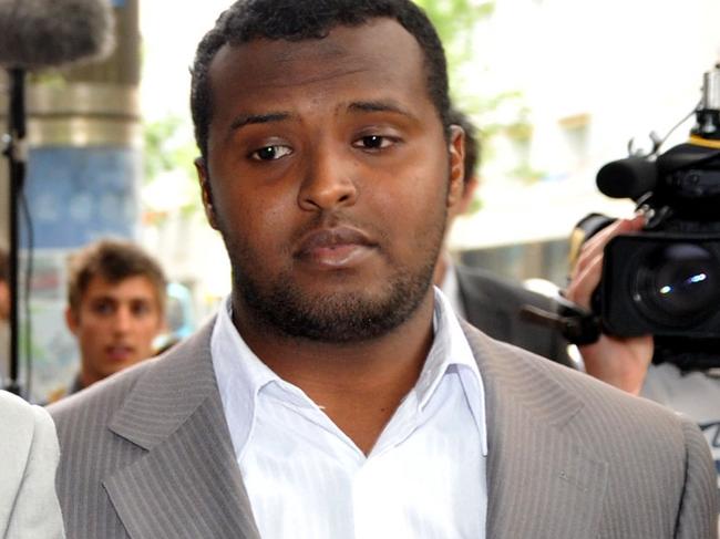 **FILE** A Thursday, Dec. 23, 2010 file photo of Yacqub Khayre (centre) leaving court in Melbourne. The gunman at the centre of Monday night's Melbourne hostage attack has been named in the media as Yacqub Khayre who was acquitted over the Holsworthy terror plot in 2009. (AAP Image/Julian Smith) NO ARCHIVING