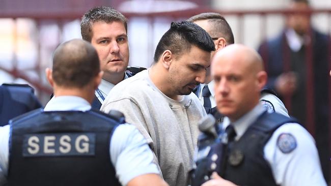 James Gargasoulas (centre) is transferred from a prison van at the Supreme Court in Melbourne, Tuesday, June 19, 2018. (AAP Image/Julian Smith) NO ARCHIVING