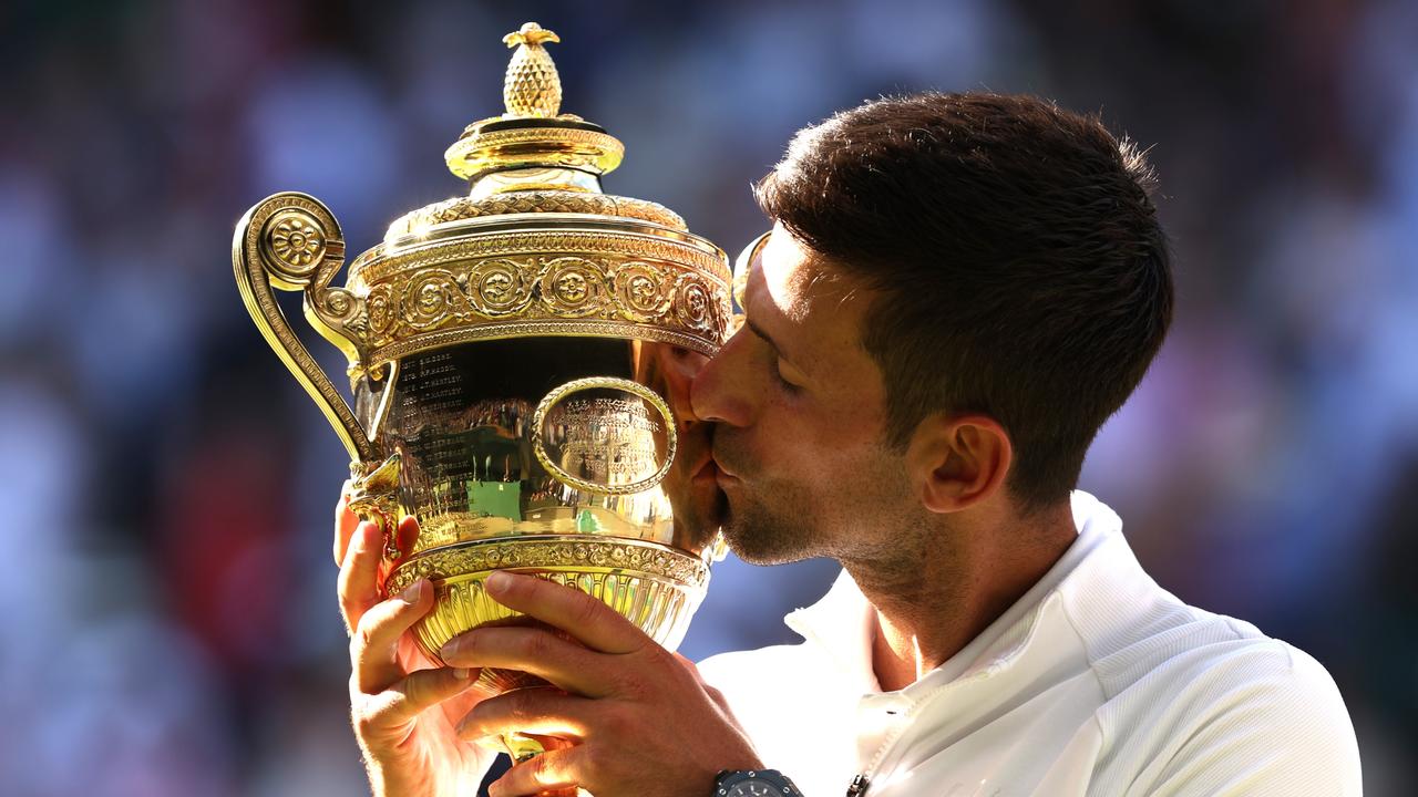 Novak Djokovic kisses the trophy following his victory against Nick Kyrgios in the Wimbledon Men’s Singles Final. Picture: Julian Finney/Getty Images