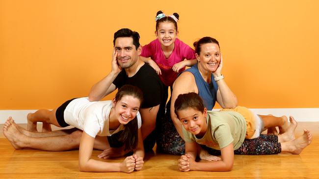 One Family Yoga &amp; Fitness Family owners Victor and Lainie Vicencio-Jenkins and their children Jasmin (youngest), Nicolas and Sofia in Holland Park. Picture: David Clark