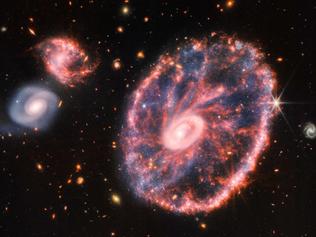 This composite image from Webbâs Near-Infrared Camera (NIRCam) and Mid-Infrared Instrument (MIRI) released by NASA on August 2, 2022, shows the Cartwheel and its companion galaxies, revealing details that are difficult to see in the individual images alone. - This galaxy formed as the result of a high-speed collision that occurred about 400 million years ago. The Cartwheel is composed of two rings, a bright inner ring and a colorful outer ring. Both rings expand outward from the center of the collision like shockwaves. This snapshot provides perspective on what happened to the galaxy in the past and what it will do in the future. (Photo by Space Telescope Science Institut / NASA / AFP) / RESTRICTED TO EDITORIAL USE - MANDATORY CREDIT "AFP PHOTO / NASA" - NO MARKETING NO ADVERTISING CAMPAIGNS - DISTRIBUTED AS A SERVICE TO CLIENTS