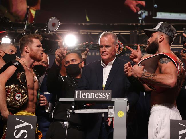 LAS VEGAS, NEVADA - NOVEMBER 05: Canelo Alvarez and Caleb Plant face off face off during their official weigh-in at MGM Grand Garden Arena on November 5, 2021 in Las Vegas, Nevada. They will fight for Alvarez's WBC, WBO and WBA super middleweight titles, and Plant's IBF super middleweight title at the MGM Grand Garden Arena on November 6, 2021 in Las Vegas.   Al Bello/Getty Images/AFP == FOR NEWSPAPERS, INTERNET, TELCOS & TELEVISION USE ONLY ==