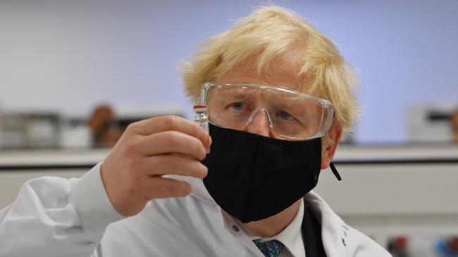 Mr Johnson with a vial of the AstraZeneca/Oxford University COVID-19 candidate vaccine, known as AZD1222, at Wockhardt's pharmaceutical manufacturing facility on Monday. Picture: Getty Images