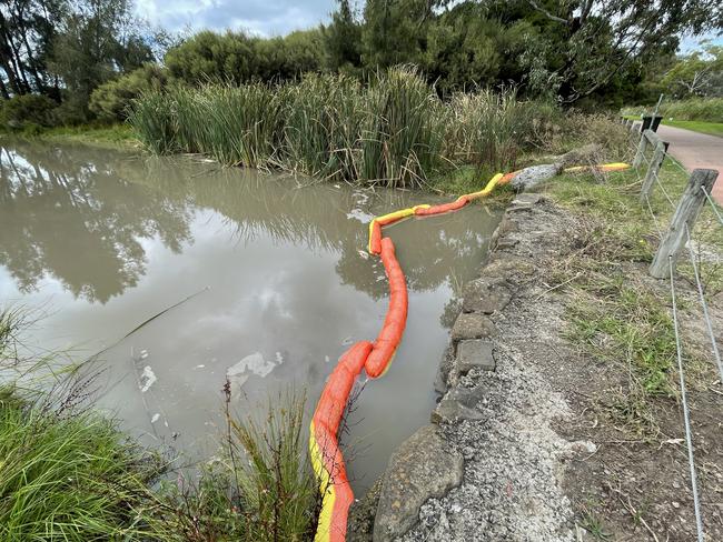 Booms have been installed by Melbourne Water to minimise pollution spread at Cherry Lake.