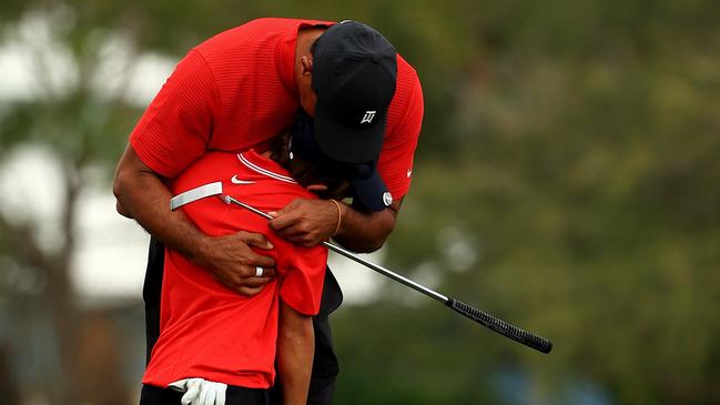 Tiger Woods embraces his son Charlie Woods on the 18th hole of the PNC Championship Mike Ehrmann/Getty Images/AFP