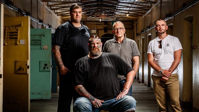 Former Finks and Mongols MC members Matt and Tyson Ward (sitting), Henry Keogh and Arcofyre Founder and CEO Kirby Brownlow at the old Adelaide Gaol. Picture: Matt Turner