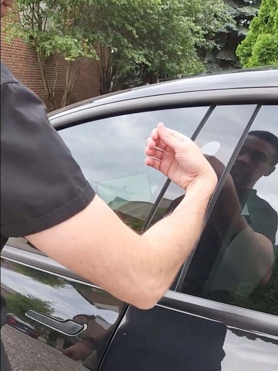 Dalaly had to rub his hand against the Tesla for a few moments before it opened. Picture: Twitter/@BrandonDalaly.