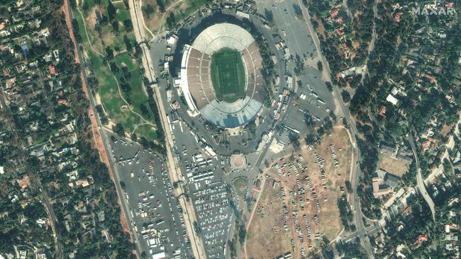 This satellite image taken shows fire fighters and fire victims at the Rose Bowl Stadium in Pasadena, California, as the Eaton Fire continues to burn. Picture: Maxar Technologies / AFP