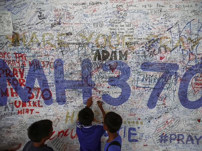 Children write messages of hope for passengers of missing Malaysia Airlines Flight MH370, which disappeared in 2014. Picture: Reuters/Samsul Said