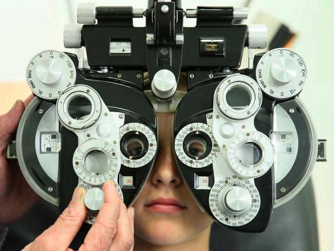 Optometrist Trevor Scott conducts an eyesight test on a child. Picture: Troy Snook