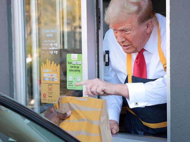 FEASTERVILLE-TREVOSE, PENNSYLVANIA - OCTOBER 20: Republican presidential nominee, former U.S. President Donald Trump works the drive-through line as he visits a McDonald's restaurant on October 20, 2024 in Feasterville-Trevose, Pennsylvania. Trump is campaigning the entire day in the state of Pennsylvania. Trump and Democratic presidential nominee Vice President Kamala Harris continue to campaign in battleground swing states ahead of the November 5th election.   Win McNamee/Getty Images/AFP (Photo by WIN MCNAMEE / GETTY IMAGES NORTH AMERICA / Getty Images via AFP)