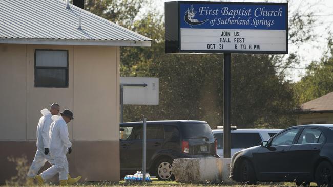 Members of the FBI walk next to the First Baptist Church in Sutherland Springs. Picture: AP