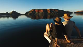 ESCAPE: KIMBERLEY CRUISE  ..  John Huxley story  ..   Couple sitting on boat on Lake Argyle.  Picture: Tourism Western Australia