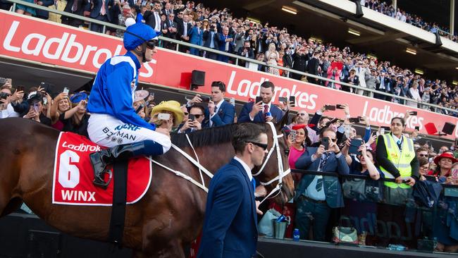 Cox Plate day at Moonee Valley Racecourse. Winx and Hugh Bowman get led onto the race course by track rider , Ben Cadden. Ben Picture Jay Town