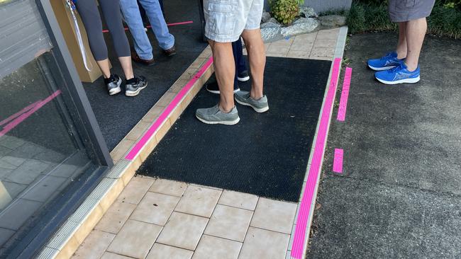 The entry to pre-polling on Lake Rd, Port Macquarie, marked with pink tape to encourage social distancing.