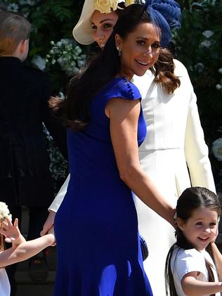 Meghan Markle's friend, Canadian fashion stylist Jessica Mulroney holds bridesmaids hands as they arrive for the wedding. Picture: AFP PHOTO / POOL / Ben STANSALL