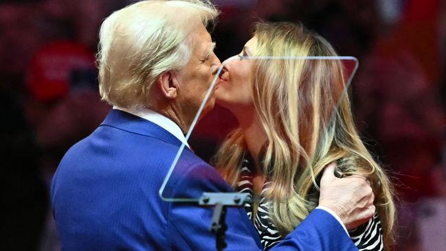 Former US President and Republican presidential candidate Donald Trump kisses former First Lady Melania Trump on stage during a campaign at Madison Square Garden in New York, October 27, 2024. (Photo by ANGELA WEISS / AFP)