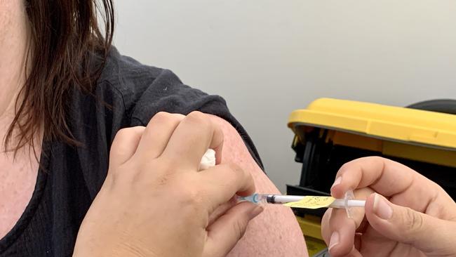 A worker getting her Covid-19 Pfizer vaccination.