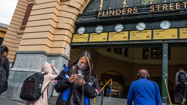 A woman wearing a face mask outside Flinders Street station. Picture: Asanka Ratnayake/Getty Images