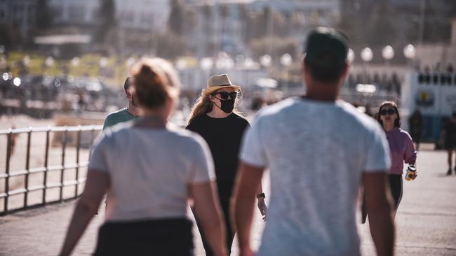 Some beachgoers at Bondi Beach, Sydney, where masks to prevent the spread of coronavirus. Picture: NCA NewsWire/Flavio Brancaleone