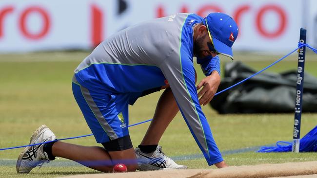 Australian spinner Nathan Lyon inspects the pitch before the Test at Galle in 2016