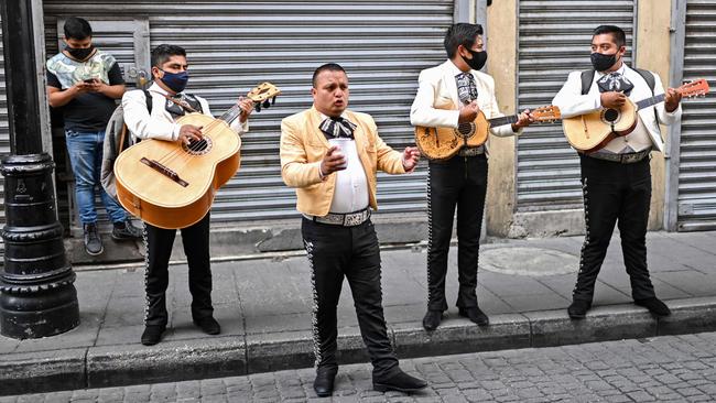 Out-of-work mariachi in Mexico City perform on the street to earn some cash. Picture: Pedro Pardo/AFP