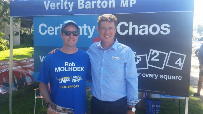 Southport LNP incumbent Rob Molhoek casts his vote at Labrador State School with the support of his son David.