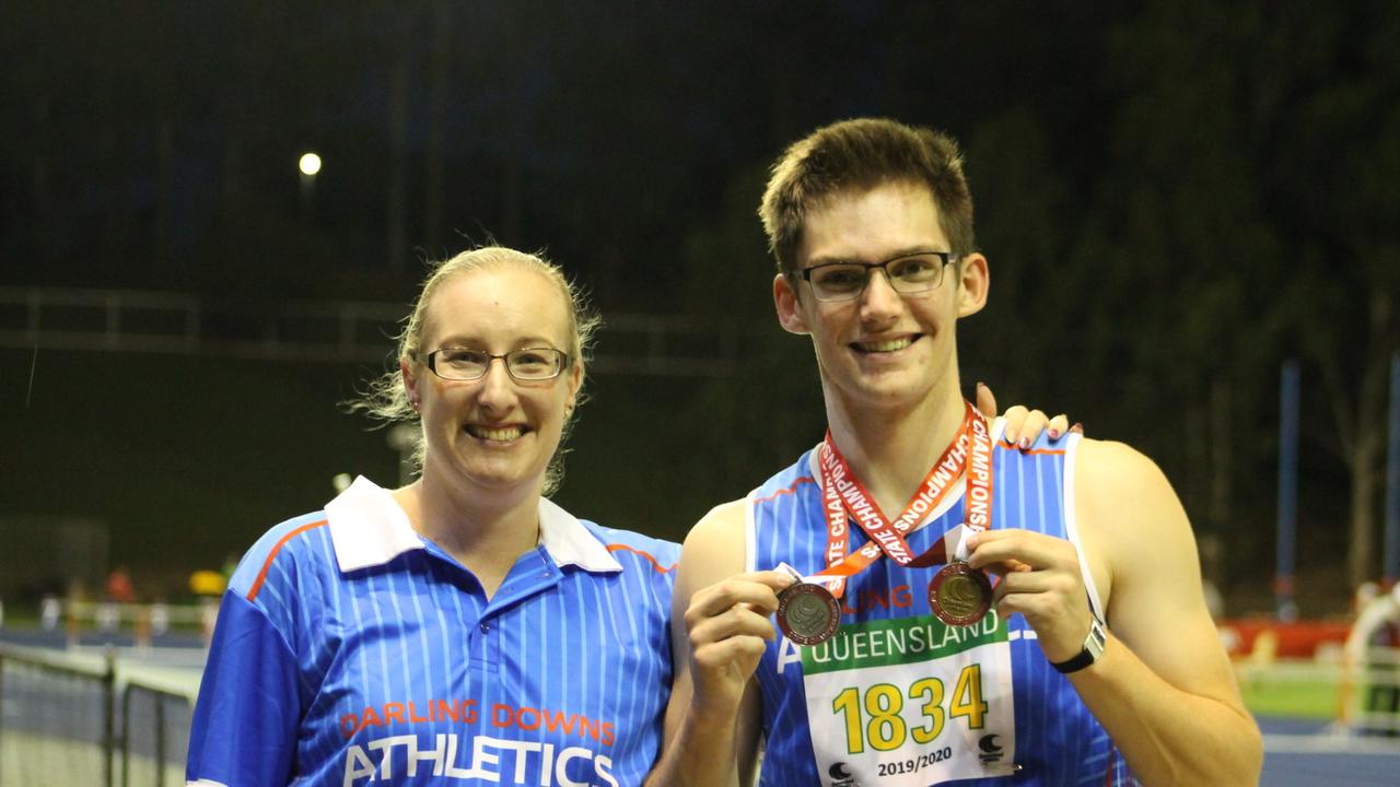 Queensland state championship dual gold medalist Mason Hughes with Darling Downs Athletics secretary-treasurer Natalie Wright.