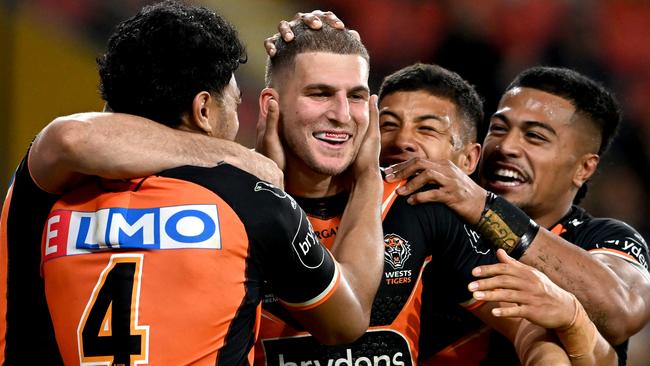 BRISBANE, AUSTRALIA - JULY 30: Adam Doueihi of the Tigers is congratulated by team mates after scoring a try during the round 20 NRL match between the Brisbane Broncos and the Wests Tigers at Suncorp Stadium, on July 30, 2022, in Brisbane, Australia. (Photo by Bradley Kanaris/Getty Images)