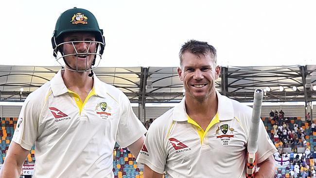 Australian openers Cameron Bancroft (left) and David Warner leave the field after the day’s play at the Gabba on Sunday.