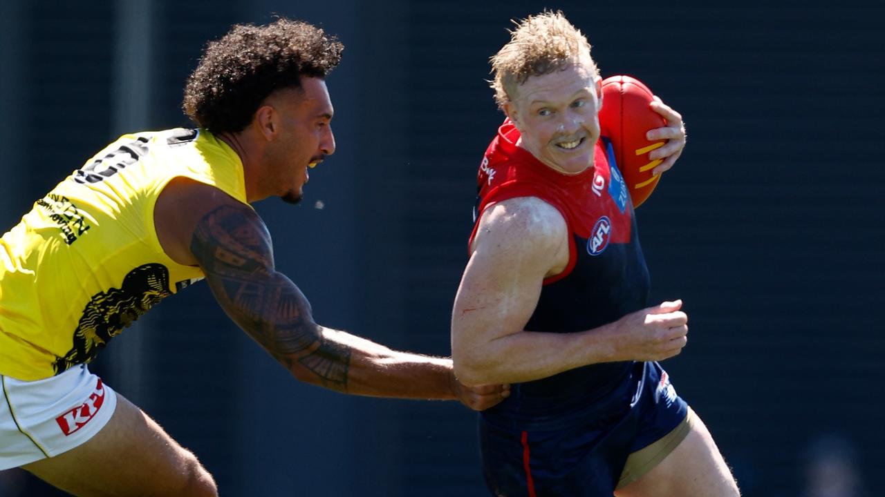 Clayton Oliver evades new Richmond recruit Mykelti Lefau during Sunday’s practice match at Casey Fields, in a performance which pleased captain Max Gawn. Picture: Michael Willson / Getty Images