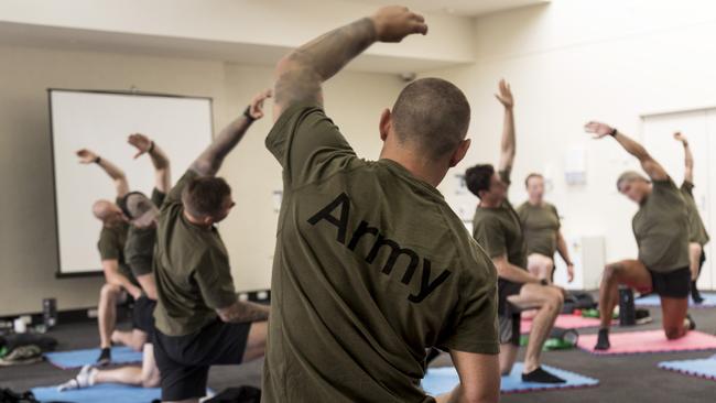 Australian Army soldiers from the Special Operations Training &amp; Education Centre are taken through a stretching session by Australian Institute of Sport staff.