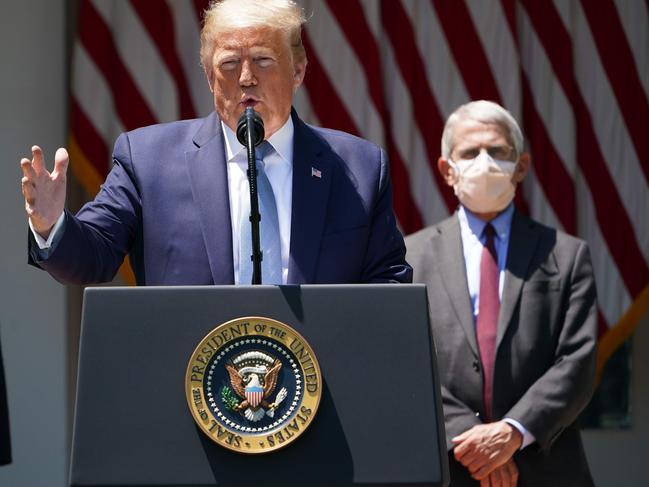 Donald Trump with director of the National Institute of Allergy and Infectious Diseases Anthony Fauci, in mask. Picture: AFP