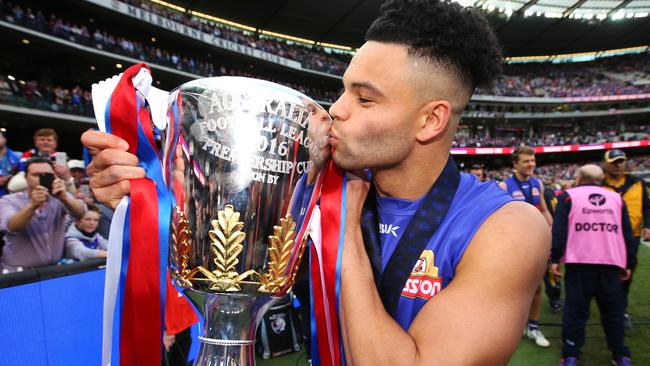 Norm Smith Medallist Jason Johannisen kisses the premiership cup.