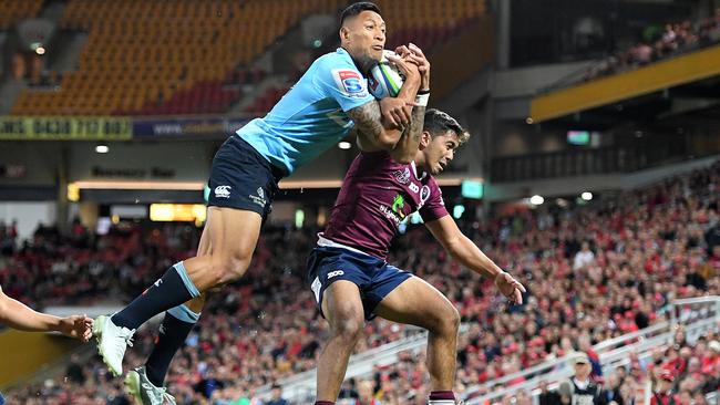 Israel Folau flies over Jayden Ngamanu at Suncorp Stadium. Picture: AAP