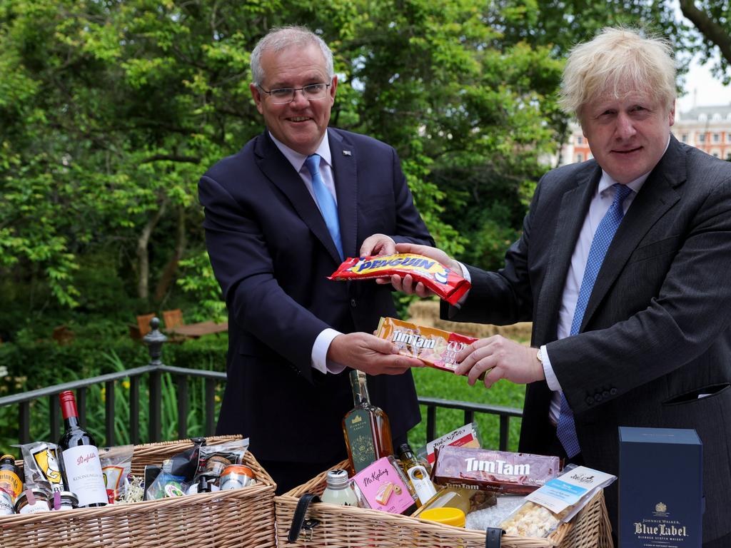 An image from Boris Johnson's Twitter account exchanging biscuits with Scott Morrison proclaiming the deal is done.