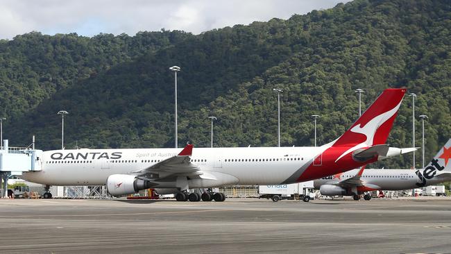 A Qantas Airbus A330 and a Jetstar Airbus A320 wide body passenger jet aircraft sit on the tarmac at the Cairns Airport international terminal. Picture: Brendan Radke