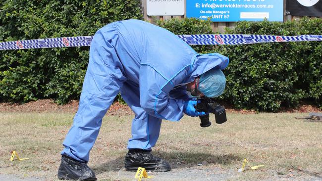 Police collect evidence at the scene. Picture: Glenn Hampson.