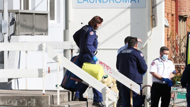 Paramedics leave the unit block after being unable to save Wes Prentice. Picture by Peter Lorimer