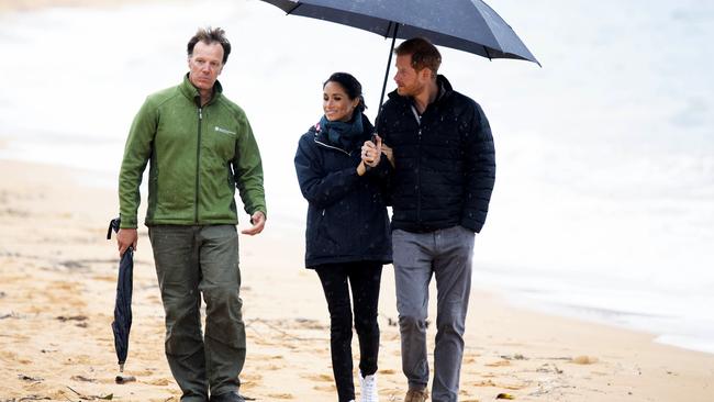 Prince Harry and Meghan Markle brave the rain at Abel Tasman National Park. Picture: Paul Edwards/AP)