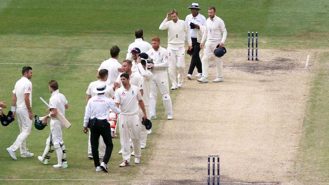 England and Australia players and umpires shake hands after the Boxing Day Test.