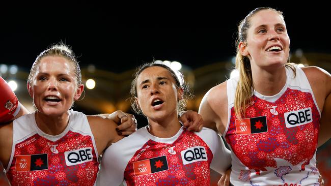 Alana Woodward, Aliesha Newman and Alice Mitchell of the Sydney Swans sing the team song after beating the Gold Coast Suns in the quarter-finals. Photo: Dylan Burns/AFL Photos via Getty Images