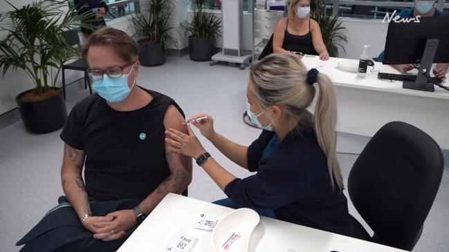 Journalist Jonathan Moran receives his Covid-19 vaccine shot at the NSW Mass Vaccination Hub in Sydney Olympic Park.