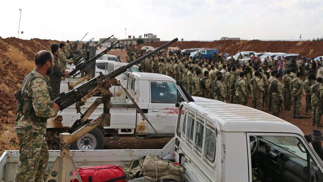 Turkish-backed Syrian rebel fighters gather near the Syrian-Turkish border north of Aleppo this week. Picture: AFP