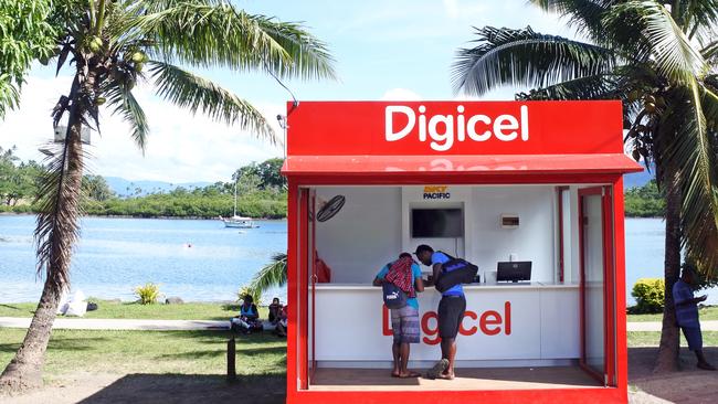 Customers shop at a Digicel mobile phone store in Savusavu, Fiji