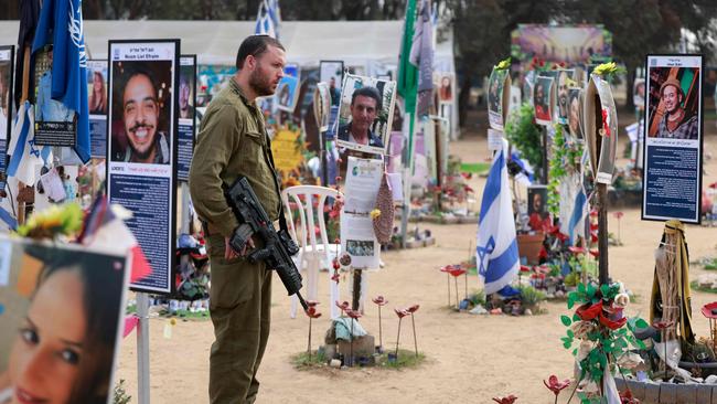 An Israeli soldier visits an installation bearing the photos of victims of the October 7, 2023 attacks at the site of the Nova festival. Picture: AFP