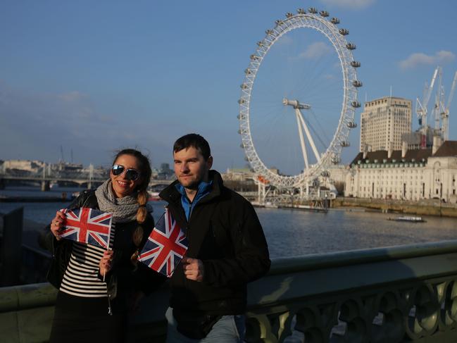 Tourists pose on Westminster Bridge with the London Eye in the background in central London on March 23, 2017 after it reopened following the March 22 terror attack at the British parliament. Picture: AFP