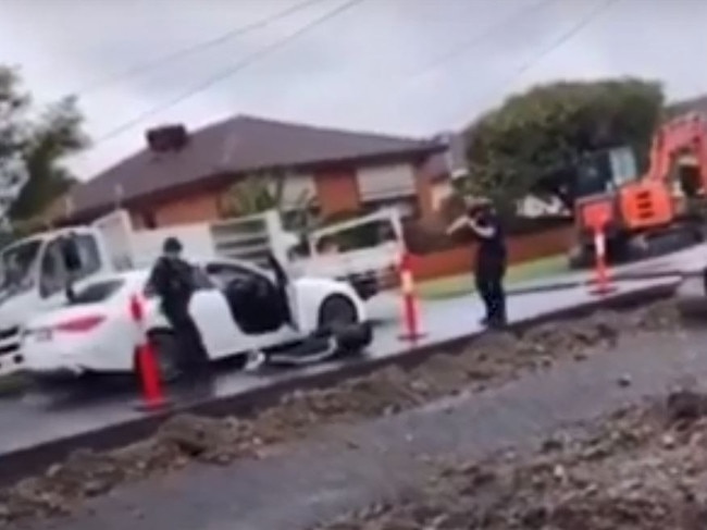 The teen then gets out of the car and lies on the ground.